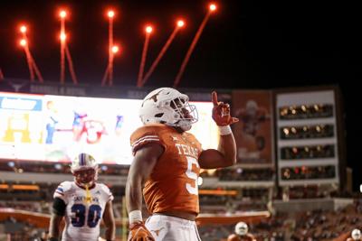 In this photo from November 13, 2021, Bijan Robinson of the Texas Longhorns reacts after scoring a touchdown in the third quarter against the Kansas Jayhawks at Darrell K Royal-Texas Memorial Stadium in Austin, Texas.