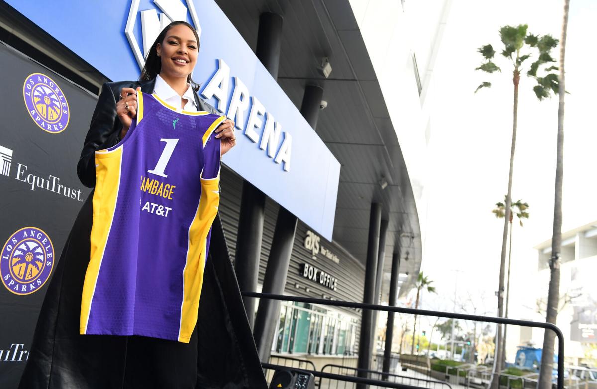 New Los Angeles Sparks player Liz Cambage holds her jersey during a press conference to announce her signing with the team outside Crypto.com Arena Wednesday, Feb. 23, 2022, in Los Angeles.