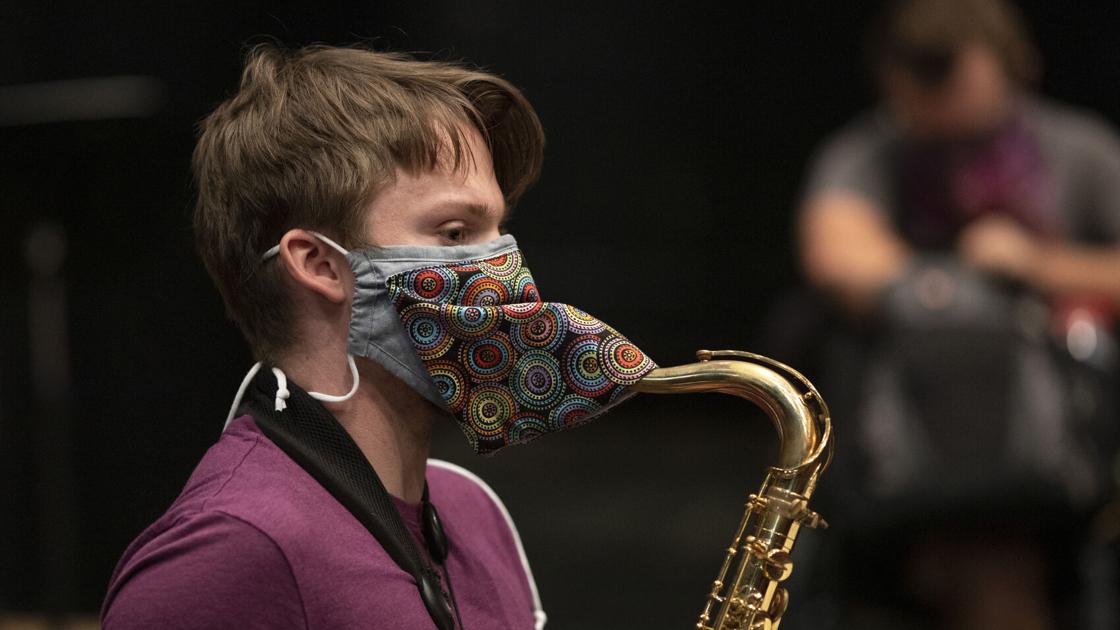 Musicians improvise masks for wind instruments to keep the band ...