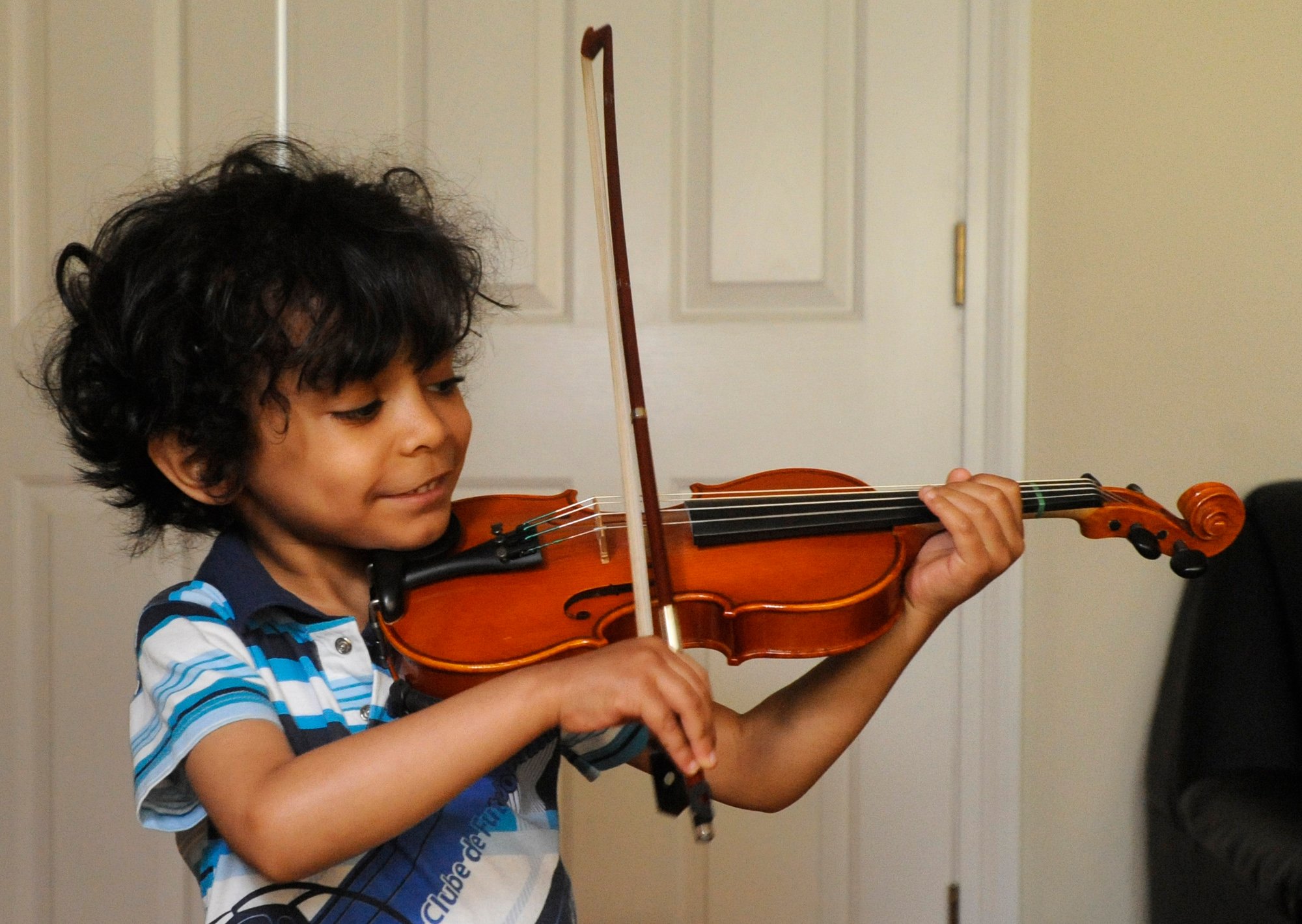 Child prodigy Caesar Sant practices violin