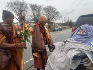 Monks stop Walk for Peace in Lexington to visit with quadriplegic woman, her mother