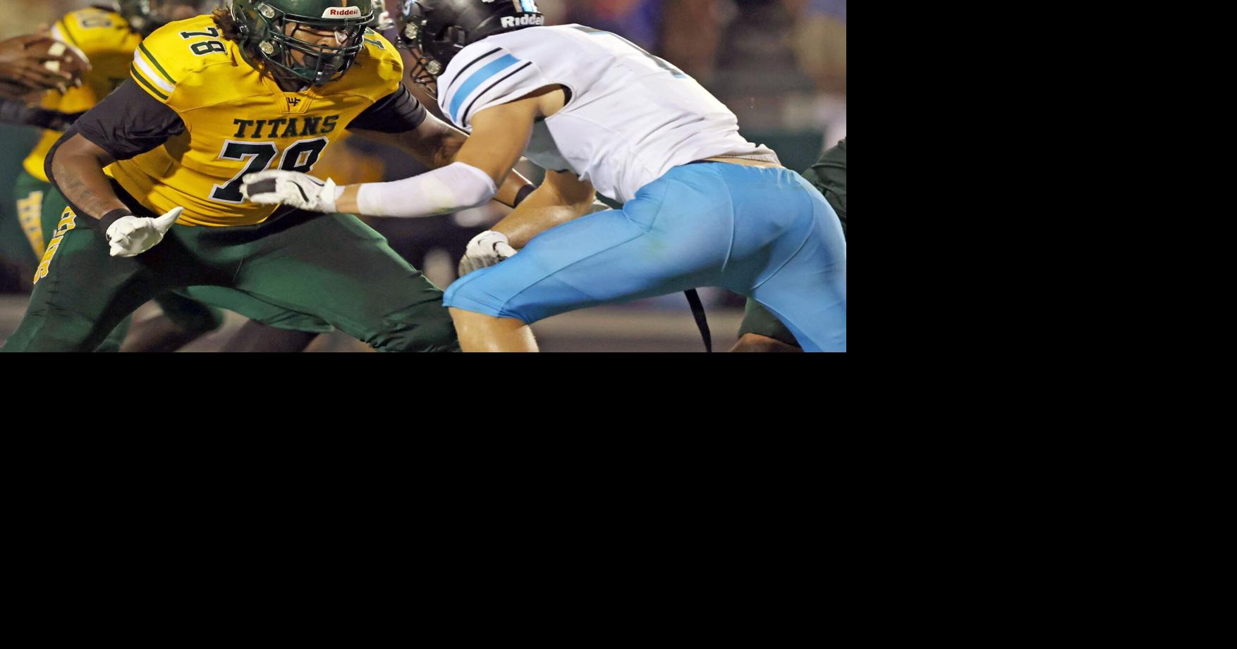 Keith Foster Jr. helps the West Forsyth football team move