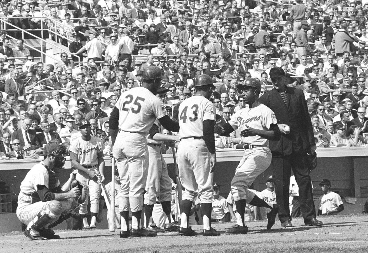 Outfielder Hank Aaron Of the Milwaukee Brewers kneels in the on