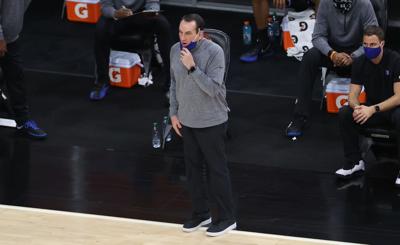 Mike Krzyzewski, head coach of the Duke Blue Devils, gives instructions to his team against the Louisville Cardinals at KFC YUM!
