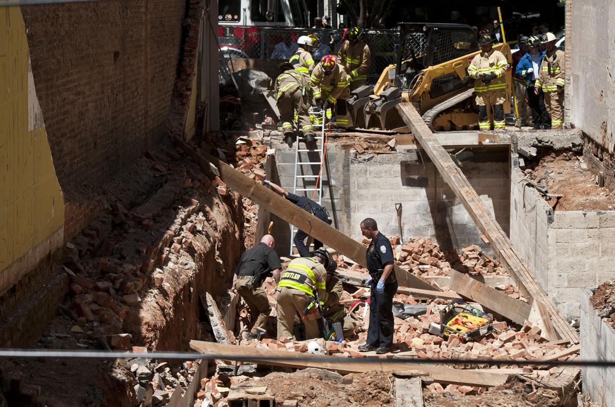 Man pinned under bricks in wall collapse identified; company faces two