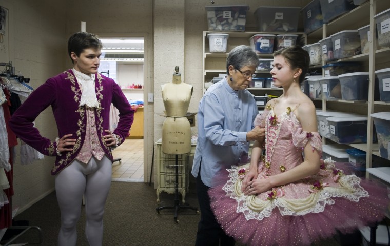 Haley Miller(right), a fourth year dance student in the high school program at UNCSA, is fitted into her Sugar Plum Fairy costume by Susan Gilmor/Winston-Salem Journal  Carolyn  Fay(center), the  director of  Dance Costumes, on Thursday, November 15, 2012 at The University of North Carolina School of the Arts Dec 2, 2012 in Winston-Salem, N.C. Tyler Sandborn(left), a sixth year dance student at UNCSA, looks on in his Cavalier costume.