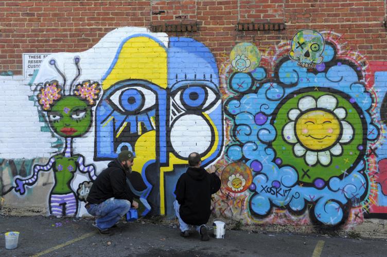 Artists work to convert graffiti to mural on Trade Street in WinstonSalem