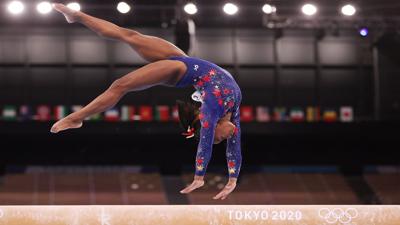 Simone Biles performs a back-handspring on balance beam during the qualification round of the women's artistic gymnastics competition in Tokyo.