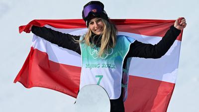Anna Gasser holds up an Austrian flag