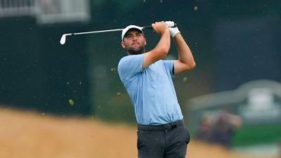 Scottie Scheffler hits the ball in the fairway of the eighteenth hole during the playoff round of the Travelers Championship golf tournament at TPC River Highlands