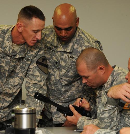 Engineers learn to disassemble a M26 shotgun