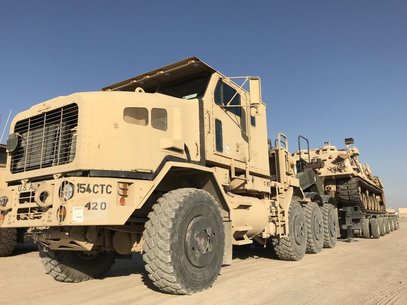 Trucking company keeps equipment, supplies rolling through desert sands