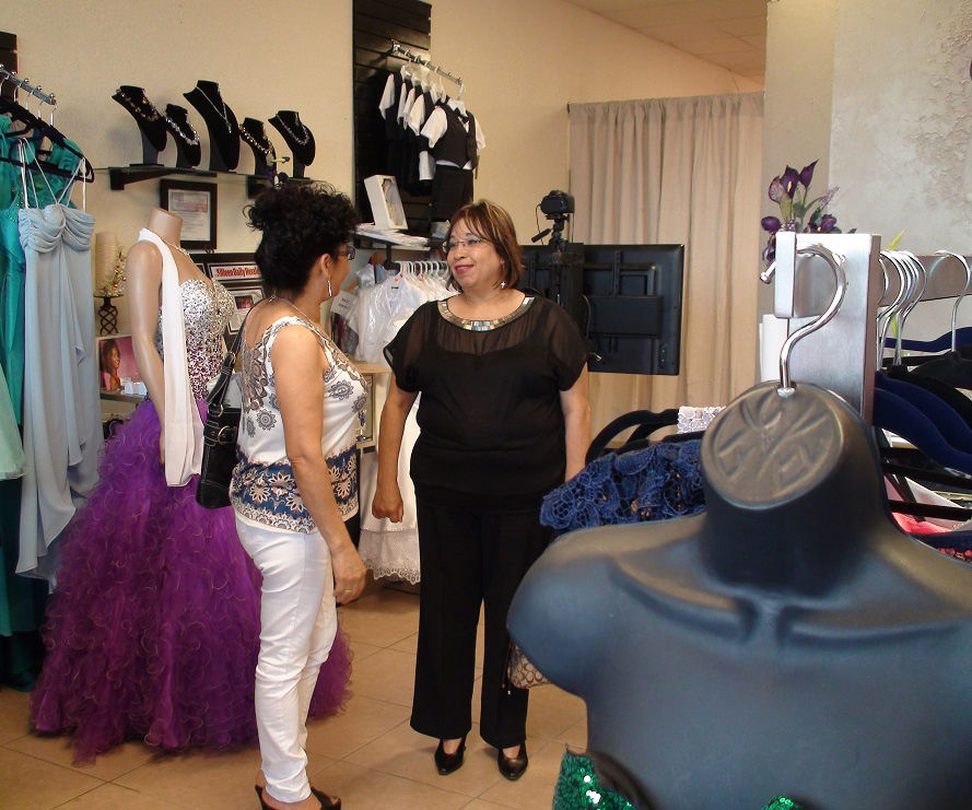 Customers view dresses during Genesis Boutique open house