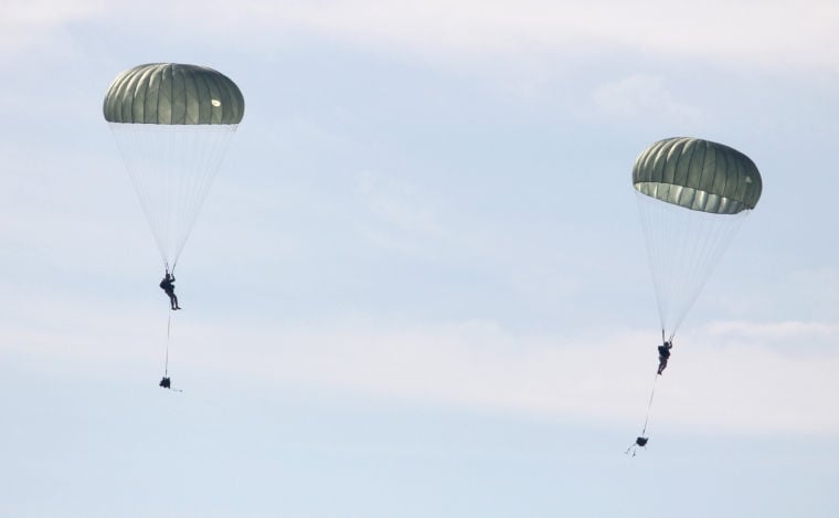 U.S. paratroopers utilizing T-11 parachutes conduct an airborne