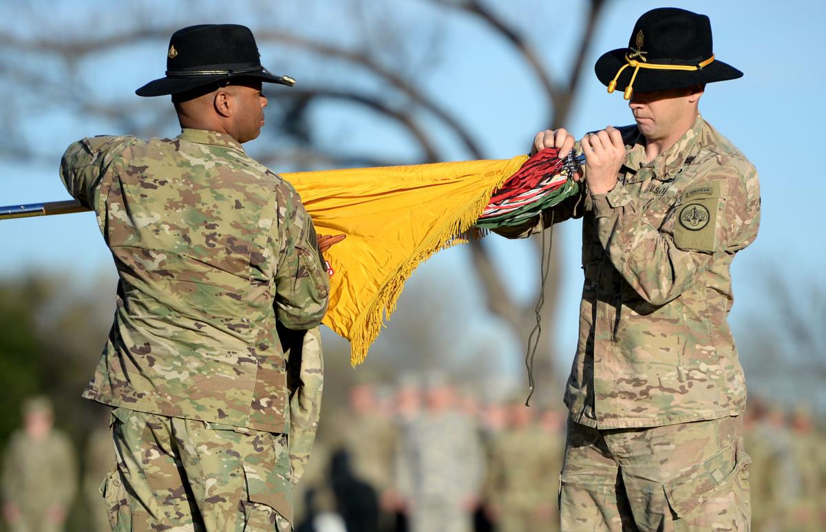 Kevin Admiral of the 3rd Cavalry Regiment uncase the colors at Cooper Field as approximately 200 sol rs return to Fort Hood after a nine