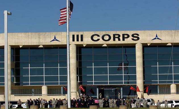 Fort Hood officials gather around flag pole