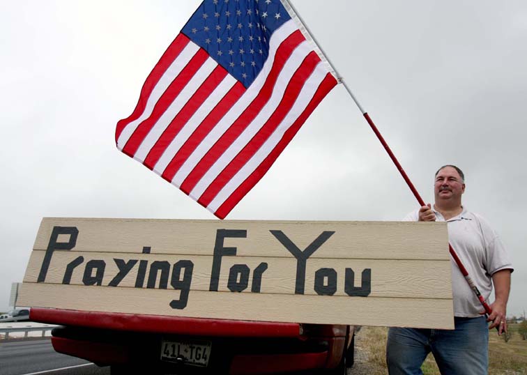 Mark Rodgers holds and American flag