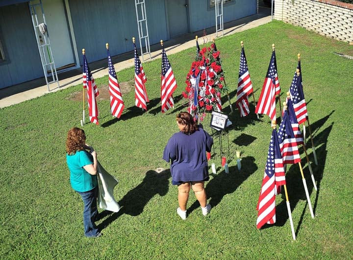 Visitors gather around a make shift memorial