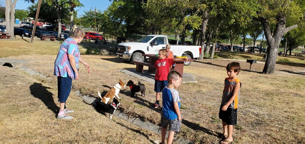 Raising Cane’s, city officials break ground on dog park in Cove
