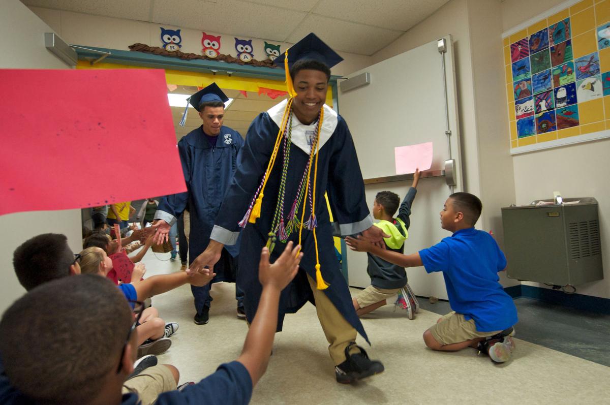 Graduation nears Seniors show off caps and gowns to elementary, middle schools Education