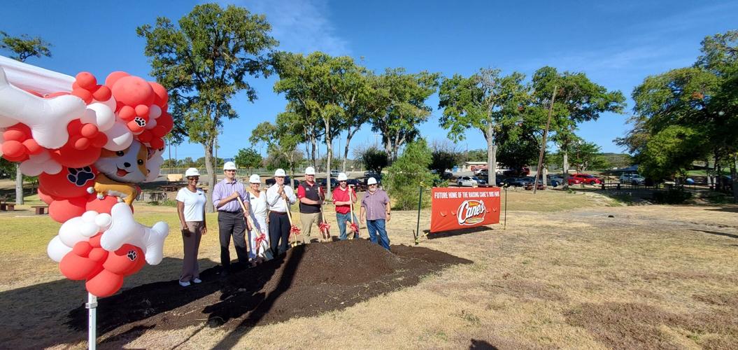 Raising Cane’s, city officials break ground on dog park in Cove
