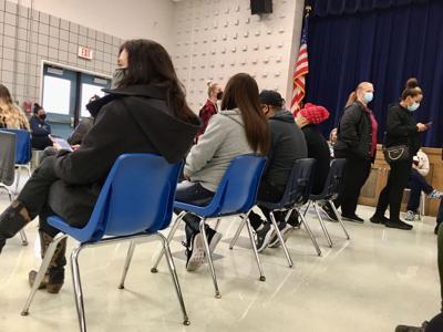 Residents wait in line at the testing site at the old Nolan Middle School in Killeen on Monday.