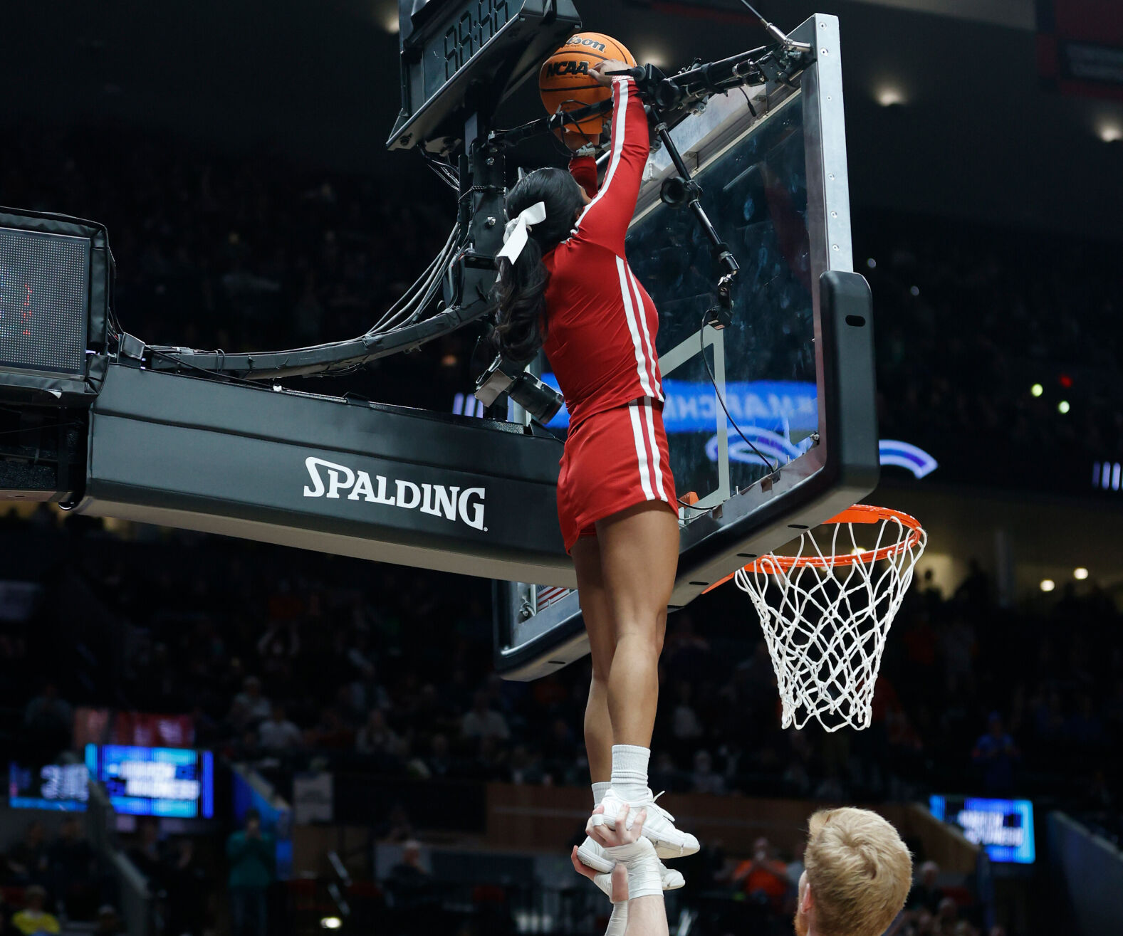 Two cheerleaders free trapped ball during March Madness game