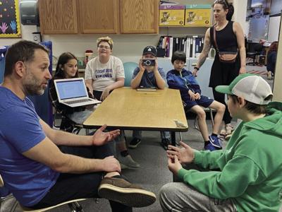 Tongass School of Arts and Sciences physical education teacher Adam Gullen, far left, participates in an interview