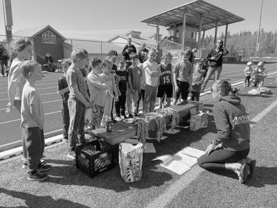 Participants in the Point Higgins Elementary Running Club await medals and participation awards