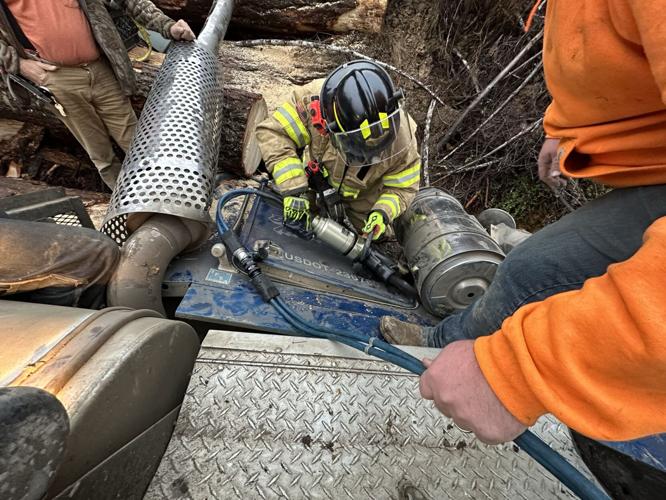 Jaws of life used to rescue driver from overturned log truck, News