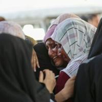 Palestinian mourn outside the Al-Shifa hospital, where casualties of Israeli strikes on Gaza City were brought
