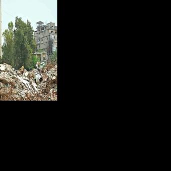 A resident inspects the rubble of destroyed buildings on his return to the southern Lebanese city of Nabatieh