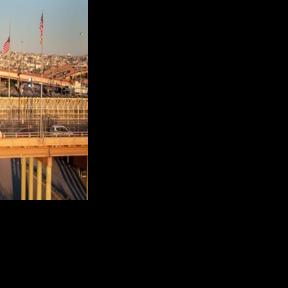 Mexican and US flags fly over the Rio Grande at their shared border in El Paso, Texas