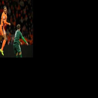 Heading to the World Cup: Virgil van Dijk of the Netherlands out jumps two Lithuanians