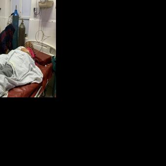 A wounded Afghan woman receives treatment at a hospital in Jalalabad after an overnight Pakistani mortar shell hit a camp for people returning from Pakistan