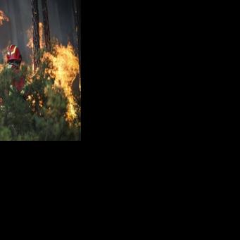 A firefighter is seen battling a wildfire burning in Gondomar, northern Portugal on July 29, 2025