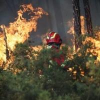 A firefighter is seen battling a wildfire burning in Gondomar, northern Portugal on July 29, 2025