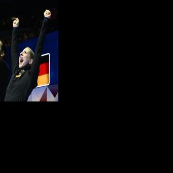 Germany’s Minerva Fabienne Hase and Nikita Volodin celebrate after winning pairs gold at the world figure skating championships in Prague