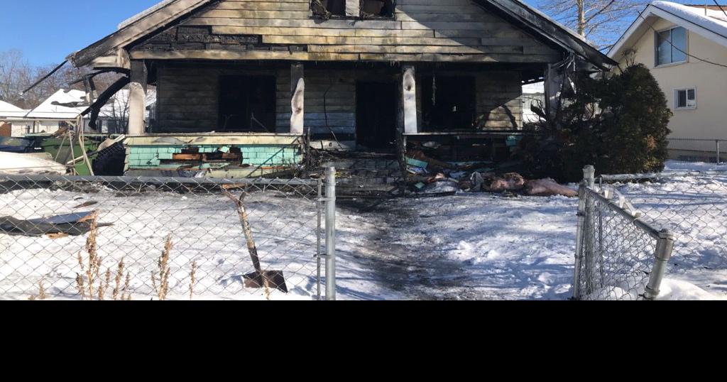 Firefighter, woman treated for minor injuries after Spokane house fire