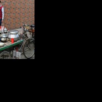 Helal Uddin, waiting for customers on a street in Dhaka, ekes out a living running a food cart and says people are now just waiting for the election
