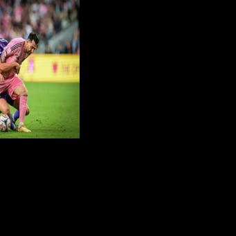 Inter Miami's Argentine forward, Lionel Messi, vies for the ball against Orlando City's Swedish defender Robin Jansson