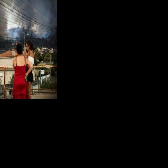 Residents watch as a wildfire burns in the surrounding hills in Gondomar, northern Portugal, on July 29, 2025