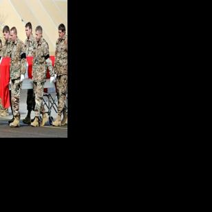 The coffins of two Danish soldiers killed in a suicide attack in Gereshk, Afghanistan, are carried out of a military transport plane at Skrydstrup Airport in Jutland, Denmark on March 23, 2008