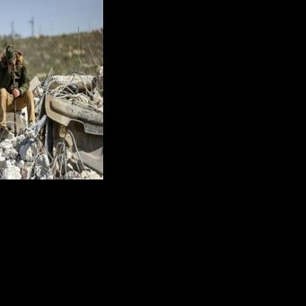 A member of the Salhab family sits on the on the rubble of an apartment building demolished by Israeli bulldozers near the Israeli settlement of Hagai in the occupied West Bank