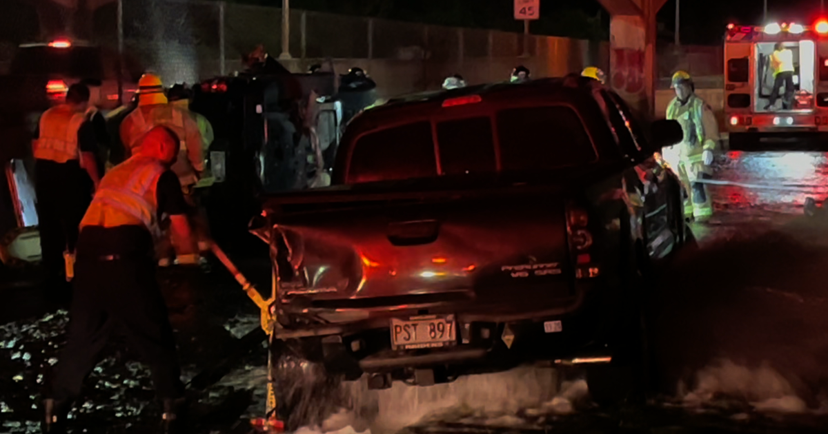 Truck lands on hydrant after McCully collision, four rescued