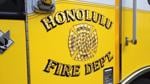 Firefighters extinguish an abandoned building fire in Waimanalo
