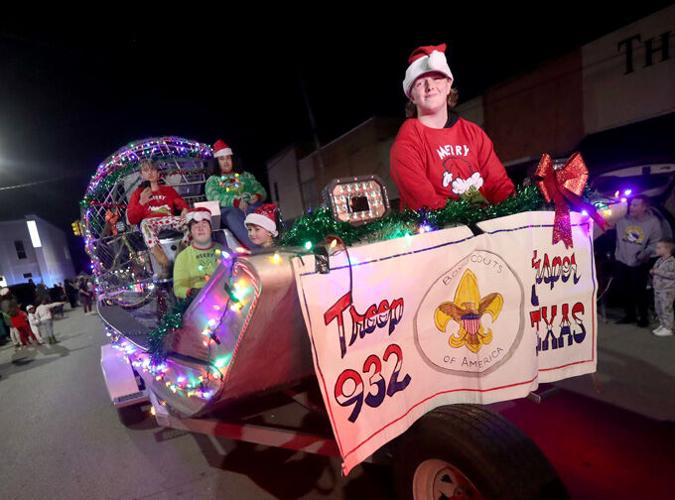 Santa Claus comes to town on top of a fire truck Local News