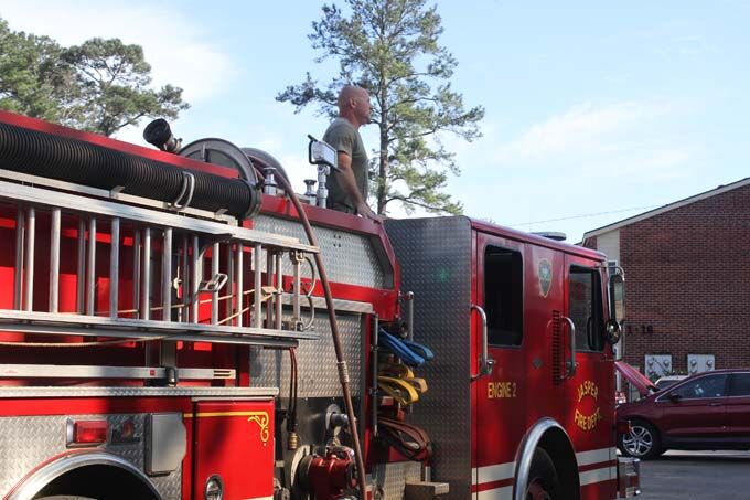 Firemen stop out of control fire before it reaches apartments and ...