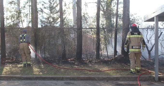 Firemen stop out of control fire before it reaches apartments and ...
