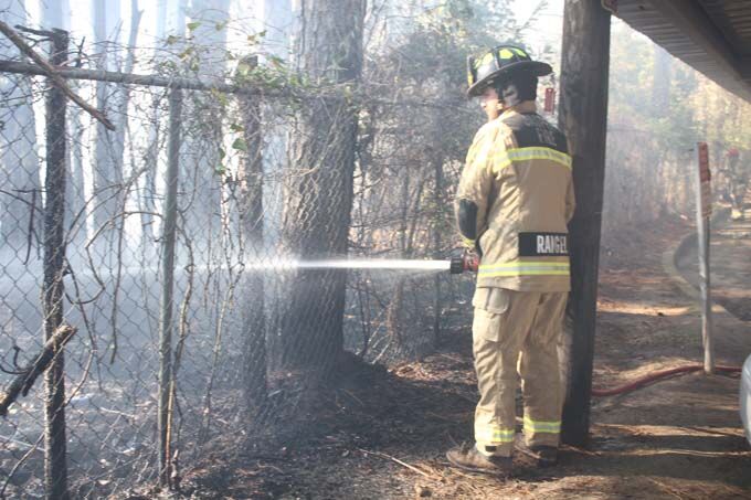 Firemen stop out of control fire before it reaches apartments and ...